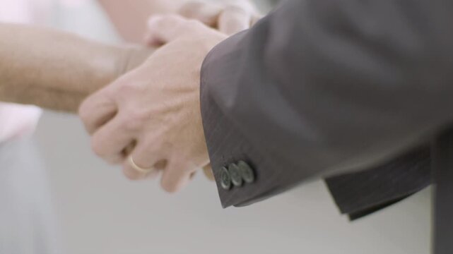close up, handshake, firm grip, two hands meeting, palm to palm, fingers intertwined, thumb lock, mutual trust, greeting gesture, deal sealed, business agreement, warm welcome, friendly clasp, 