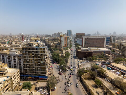 Aerial view of I.I. Chundrigar Road featuring dense urban architecture, high-rise office buildings, and busy traffic flow in the financial district of Karachi, Sindh, Pakistan.