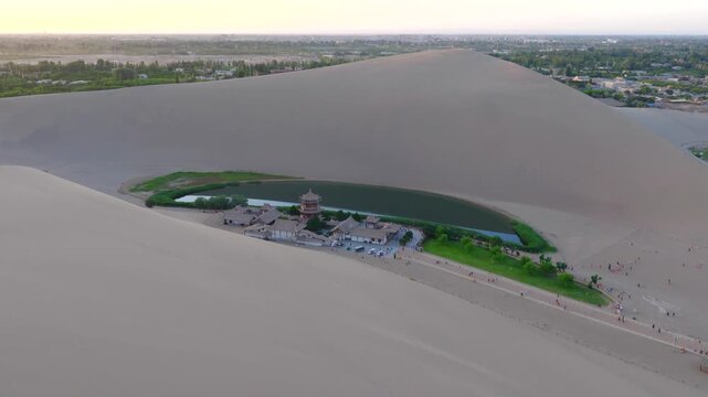 erial Drone Footage of Crescent Moon Spring, Mingsha Mountain Desert Oasis at Sunset, Dunhuang Gansu China
Panoramic Wide Shot of Dunhuang Crescent Lake Surrounded by Giant Sand Dunes, Ancient Chinese