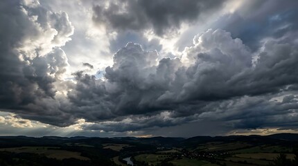 Fototapeta premium Dramatic cloudy sky over rolling hills and mountains