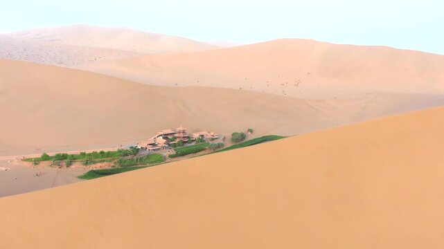 The Singing Sand Dunes and Crescent Lake in Dunhuang, Gansu, China, are a clear spring in the desert that has never dried up or been buried by sandstorms for thousands of years.