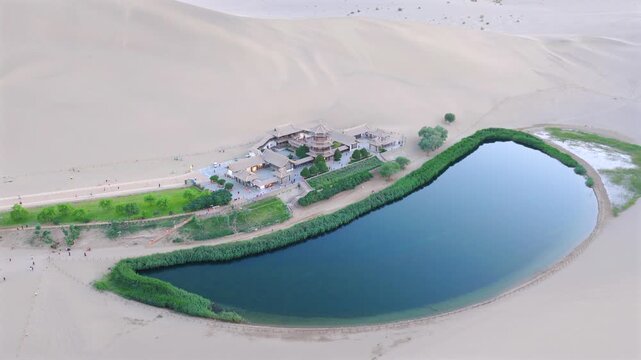 The Singing Sand Dunes and Crescent Lake in Dunhuang, Gansu, China, are a clear spring in the desert that has never dried up or been buried by sandstorms for thousands of years.