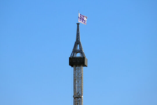 Fantasy Eiffel Tower silhouette with flag on metal lattice installation at a trade show