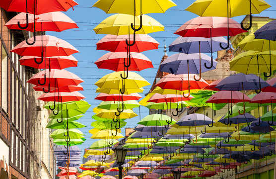 View of colorful umbrellas suspended above a street in Polczyn-Zdroj, West Pomeranian Voivodeship, Poland.