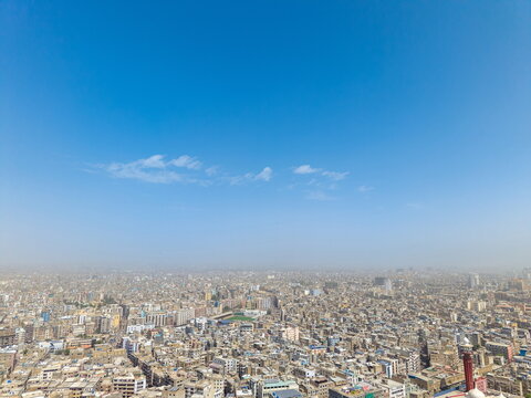 Aerial view of the dense urban landscape of Karachi, featuring the bustling I.I. Chundrigar Road area with its mix of commercial buildings and rooftops in Karachi, Sindh, Pakistan.