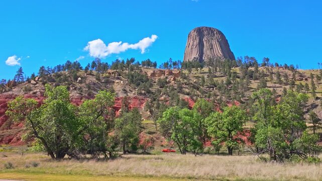 Close up view of Devils Tower National Monument rising high above the Wyoming landscape on a clear summer day