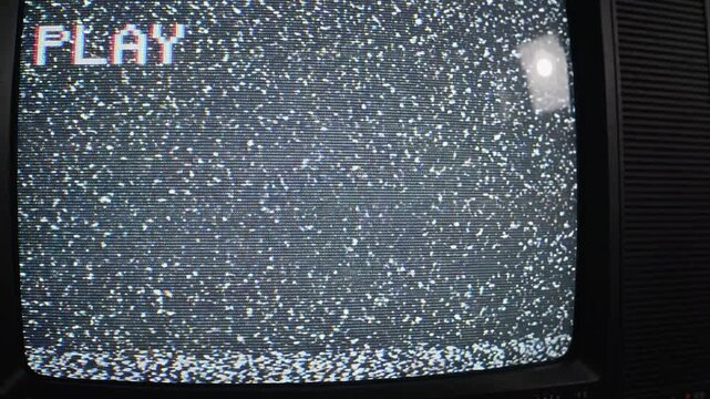 Retro TV Static with Play Symbol A vintage television screen displaying static noise with the word PLAY in the corner evoking nostalgia and a sense of analog media