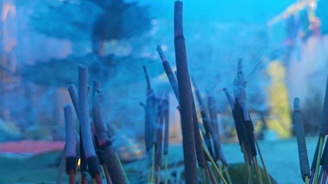 Burning incense sticks Agarbatti producing fragrant smoke during a Hindu prayer and worship ceremony. The rising smoke creates a peaceful spiritual atmosphere often associated with meditation