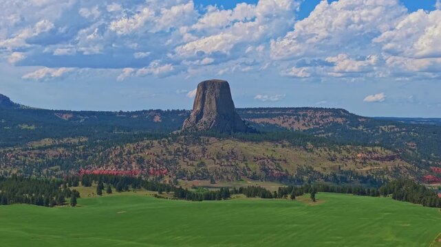 Panoramic aerial view of Devils Tower National Monument rising above the surrounding landscape in Wyoming