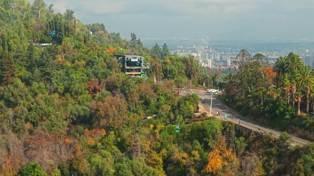 Telephoto aerial view of the San Cristobal Hill cable car with several gondolas along the route, Santiago, Chile