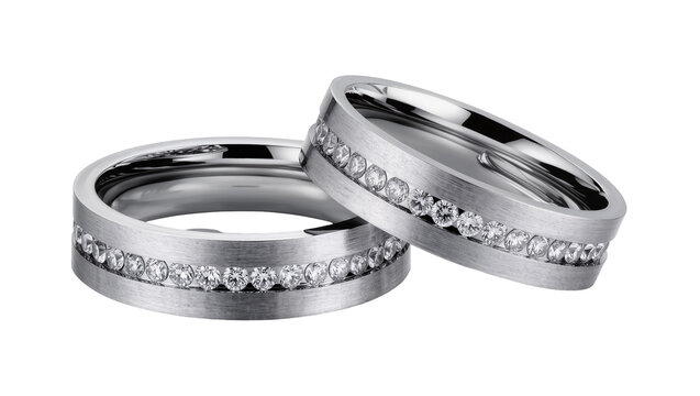 Two brushed platinum wedding bands with channel-set diamonds, isolated on transparent background
