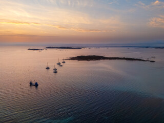 Fototapeta premium Aerial view sailboats anchoring near Corsica coastline