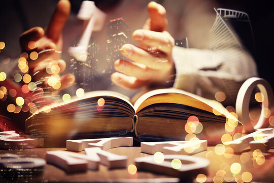 Close up of an unrecognizable man holding a book standing against a evening city panorama. Mock up, toned image, double exposure