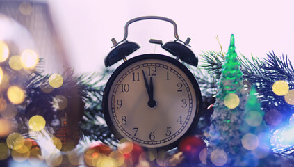 Christmas gifts, fir branches and alarm clock on wooden table. Boxing day
