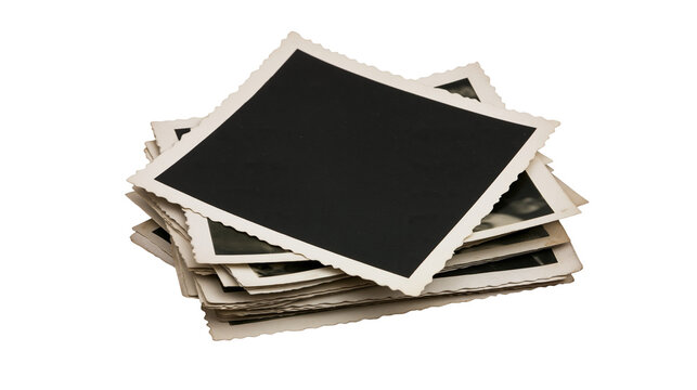 Stack of vintage black photo prints with scalloped edges, isolated on transparent background