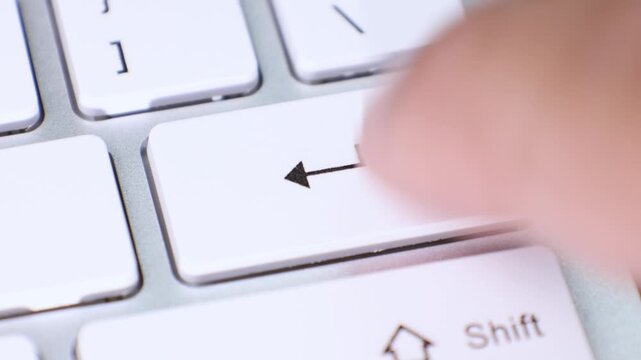 Image features a close-up view of the Enter key on a white computer keyboard. The key is clearly marked with the word Enter and a leftward arrow symbol.