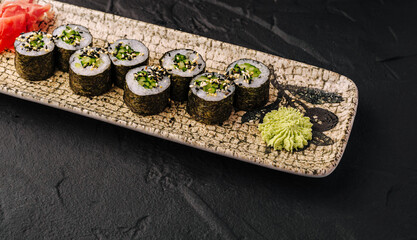 Cucumber kappa maki sushi rolls with wasabi and ginger © AntAlexStudio