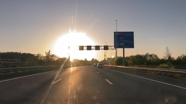 Amsterdam Netherlands highway, Sunlit highway at sunset with light traffic
