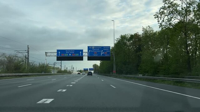 Amsterdam Netherlands highway, Light traffic on an urban highway under cloudy skies