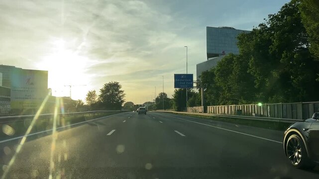Amsterdam Netherlands highway, Sunlit urban motorway with moving traffic