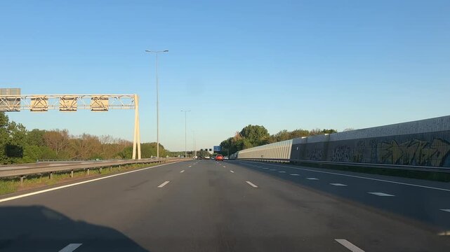 Amsterdam Netherlands highway, Cars driving on a wide urban highway under clear blue sky