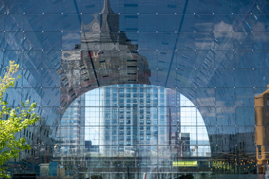 Reflective glass arch roof of Markthal Rotterdam with city reflections, sunny day, Netherlands