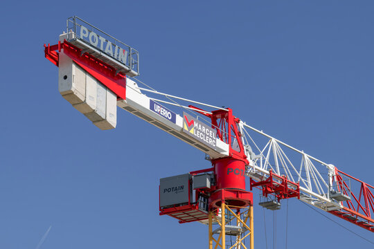 Nancy, France - June 20th 2026 : View on a flat-top tower crane Potain MDT 219 J10 on a construction site for the construction of a building.