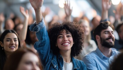 Fototapeta premium Joyful woman in denim jacket raises hand among enthusiastic concert crowd