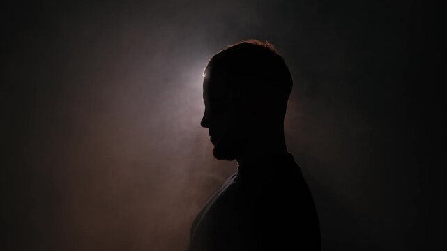 Side profile silhouette in cinematic backlight