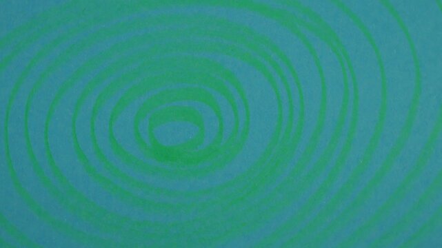 Rotation of scribbles on a blue paper