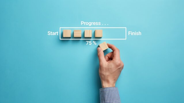Hand completing progress bar with wooden block, 75 percent finish on blue background