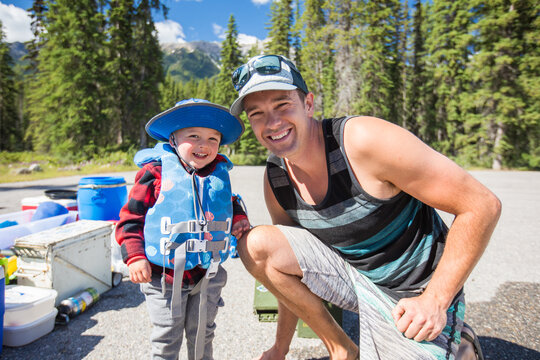 Happy father and son getting ready for outdoor adventure