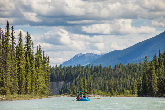 People enjoying a scenic raft trip on a mountain river
