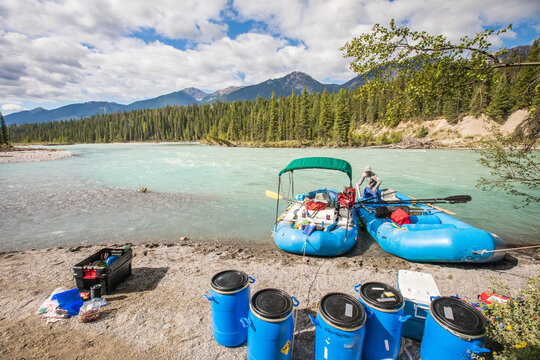 Man prepares rafts for a wilderness river expedition