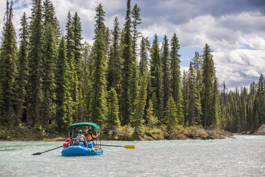 Two people enjoying a scenic river rafting trip