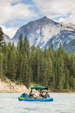 Group rafting on a scenic mountain river