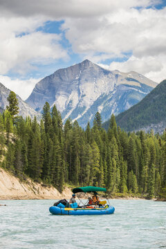 Rafters float down a scenic mountain river