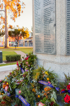 Cenotaph at sunrise with ANZAC day wreaths laid in memorial