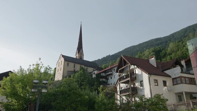Architecture of the church in Umhausen Austria surrounded by alpine mountains in Oetz Valley Tyrol with beautiful village scenery and tourism in Europe