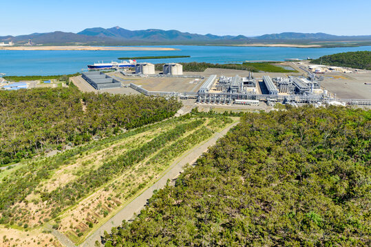 Landfill and storm water gullies with liquified natural gas in the background on Curtis Island