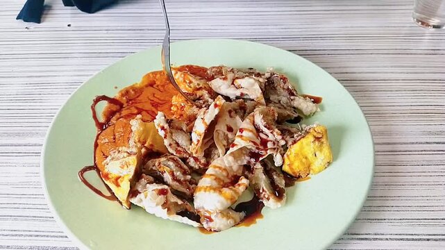 Indonesia street food called Batagor. Made from tofu and fried fish meat served with peanut sauce, sweet soy sauce, and sambal