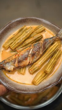 Gaeng Khua Som Marum Pla Khem, Thai sour and spicy curry with moringa pods and fish.
