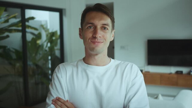 Confident man turns head looks at camera with slight smile at home Calm leadership portrait self assured entrepreneur vibe modern lifestyle personal brand success mindset business confidence male pro