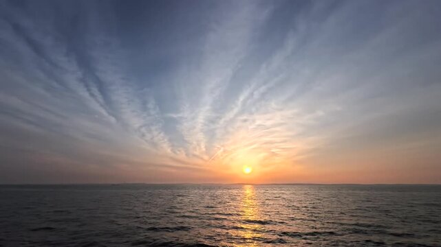 Stunning morning seascape with moving dramatic clouds in fast motion