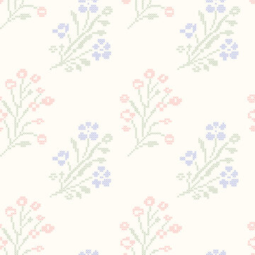 Cross stitch embroidery field flowers seamless pattern on cream background. A geometric pixelated needlework vintage wildflower wallpaper for cottagecore crafts, textiles, wrapping, fabric design.