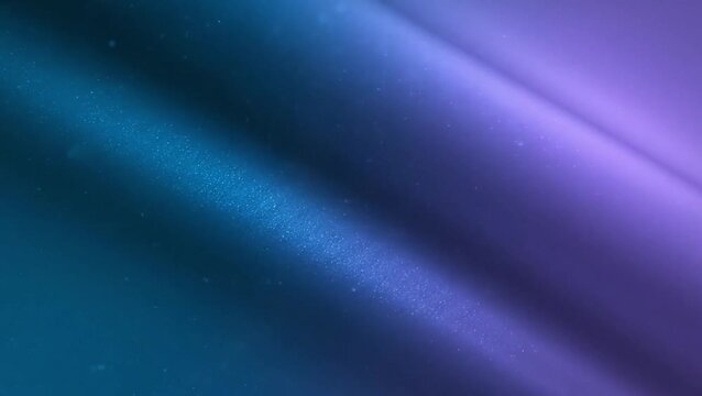 A close-up abstract view of a smooth fabric surface with a blue to purple color gradient and diagonal folds.