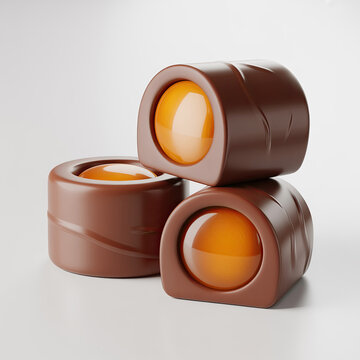Close-up of chocolate and caramel candies on white background