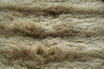 Fototapeta premium The texture of a warm fluffy sheepskin blanket