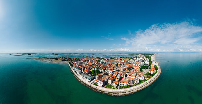Grado, Italy with coastline, sea, and old town architecture during summer