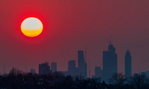 A summer setting sun over new buildings in London, UK.